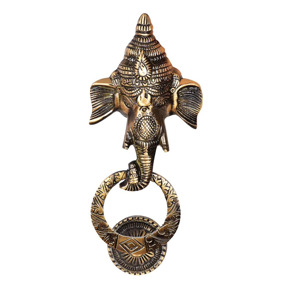 A gold-colored brass Ganesha door knocker with intricate handicraft details, showcasing the elephant head design.