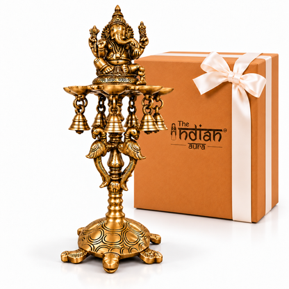 The Indian Aura Pure Brass Ganesh Diya Stand with 7 Oil Holders | Antique Finish Pooja Lamp with Hanging Bells, Peacock Design & Tortoise Base | Premium Traditional Gift for Diwali, Housewarming, Wedding, Anniversary & Festive Occasions