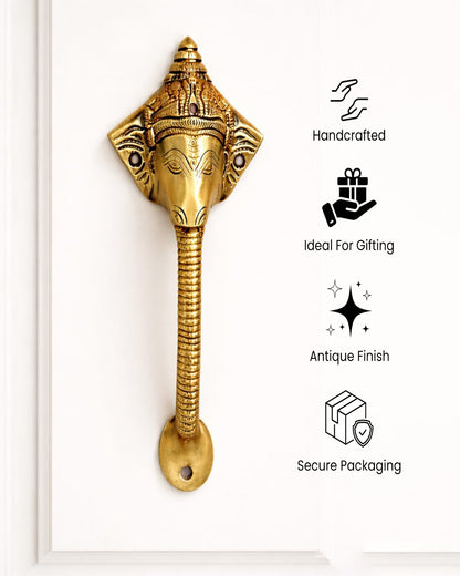 Decorative brass handle with features.