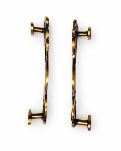 Pair of Brass Door handles on a white background.

