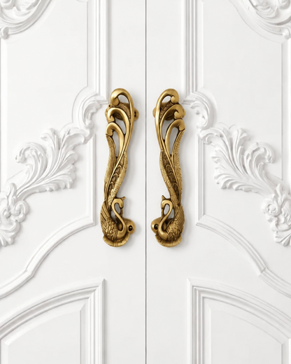 Two Brass door handles with a Swan design.
