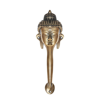 Decorative Buddha face brass handle on a white background.