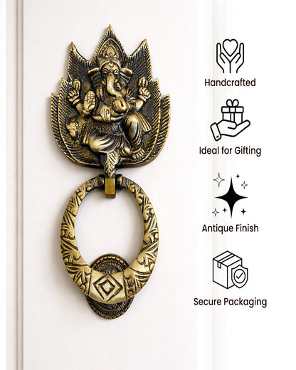 Decorative brass door knocker with Ganesha figure on a white background