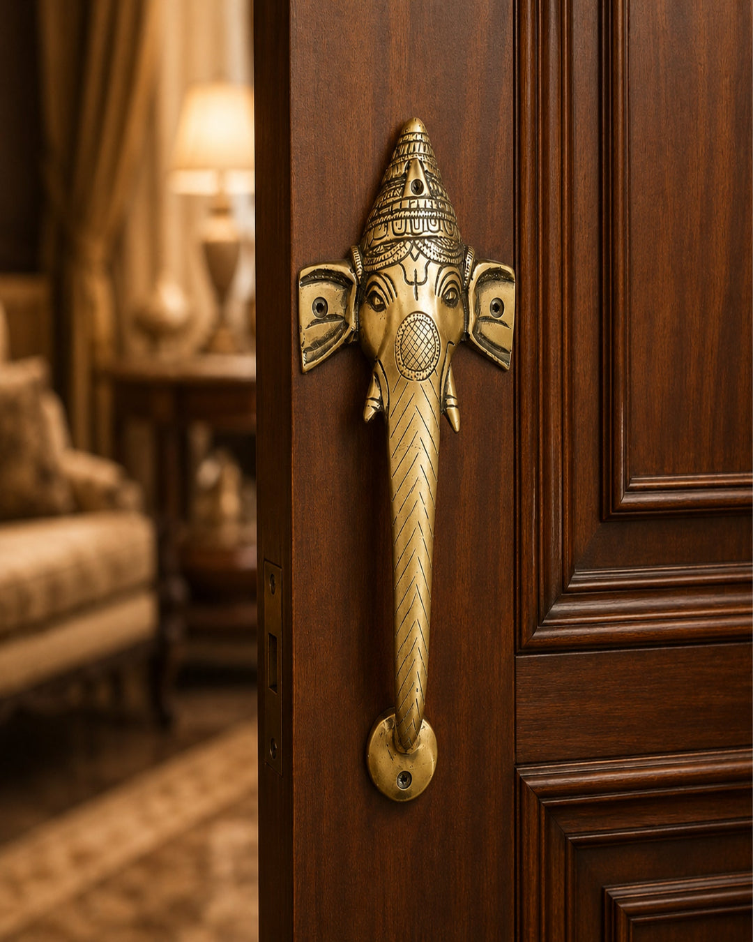 Decorative brass door handle shaped like an elephant head on a wooden door.
