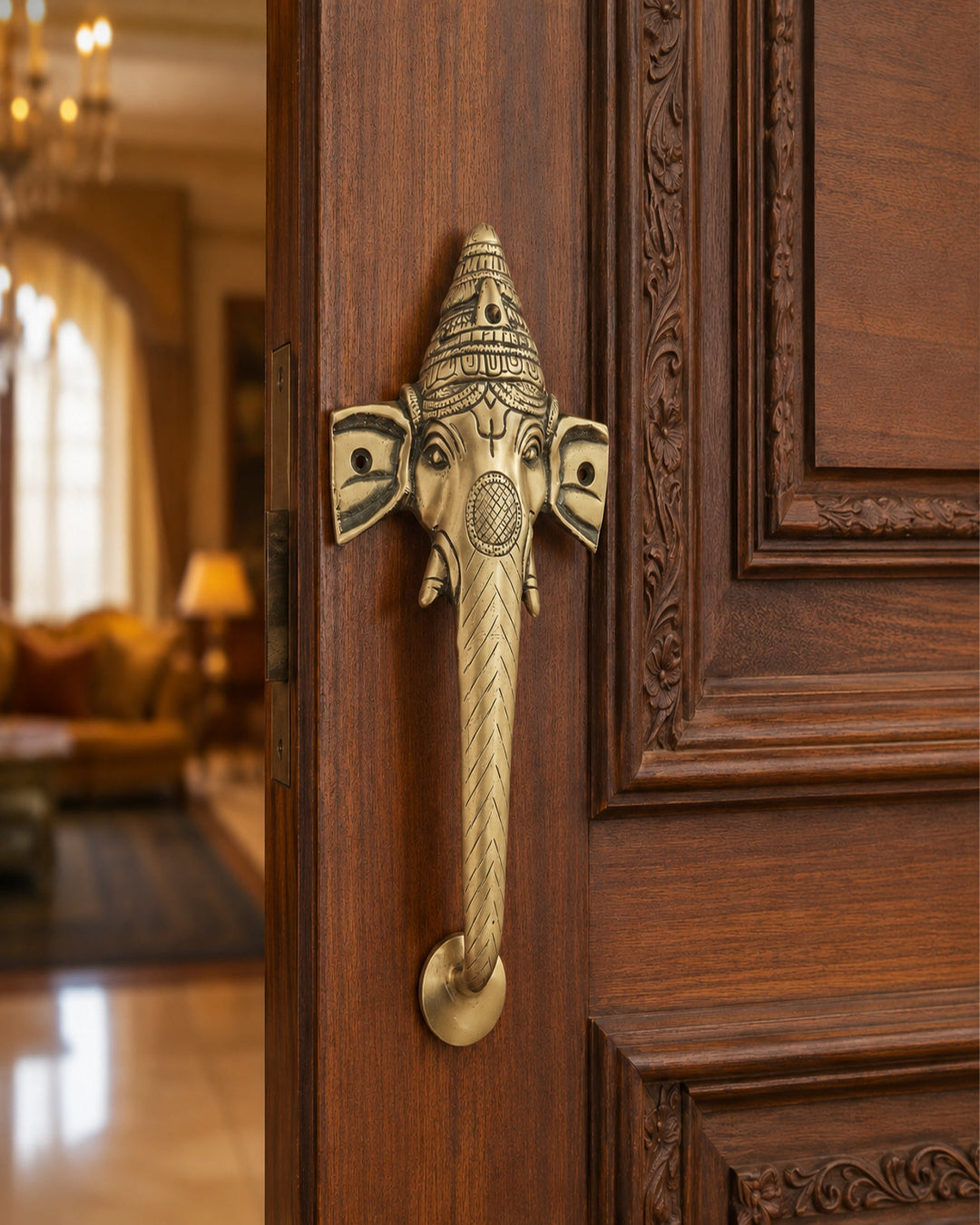 Decorative brass door handle shaped like a elephant head on a wooden door.