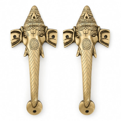 Two ganesha brass door handles on a white background.