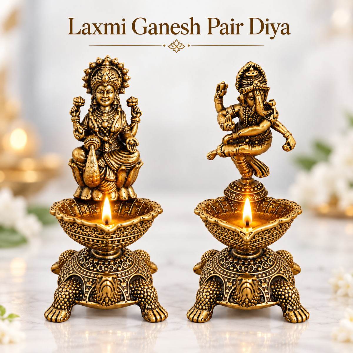 Two ornate brass-style diya holders featuring Laxmi and Ganesh figurines, each with a lit oil lamp, displayed on a light marble surface with a soft blurred festive background and the text 'Laxmi Ganesh Pair Diya' above.