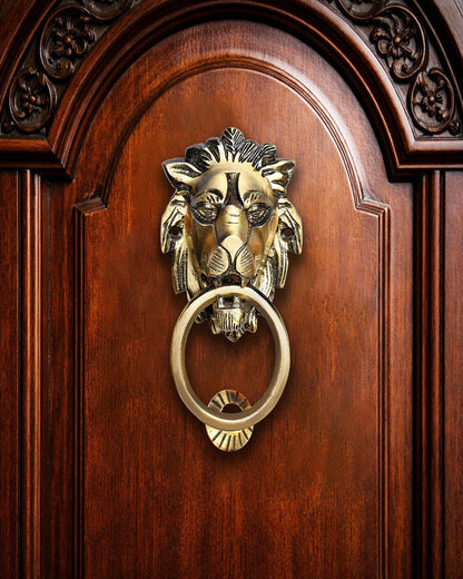 Gold lion head door knocker on a wooden door