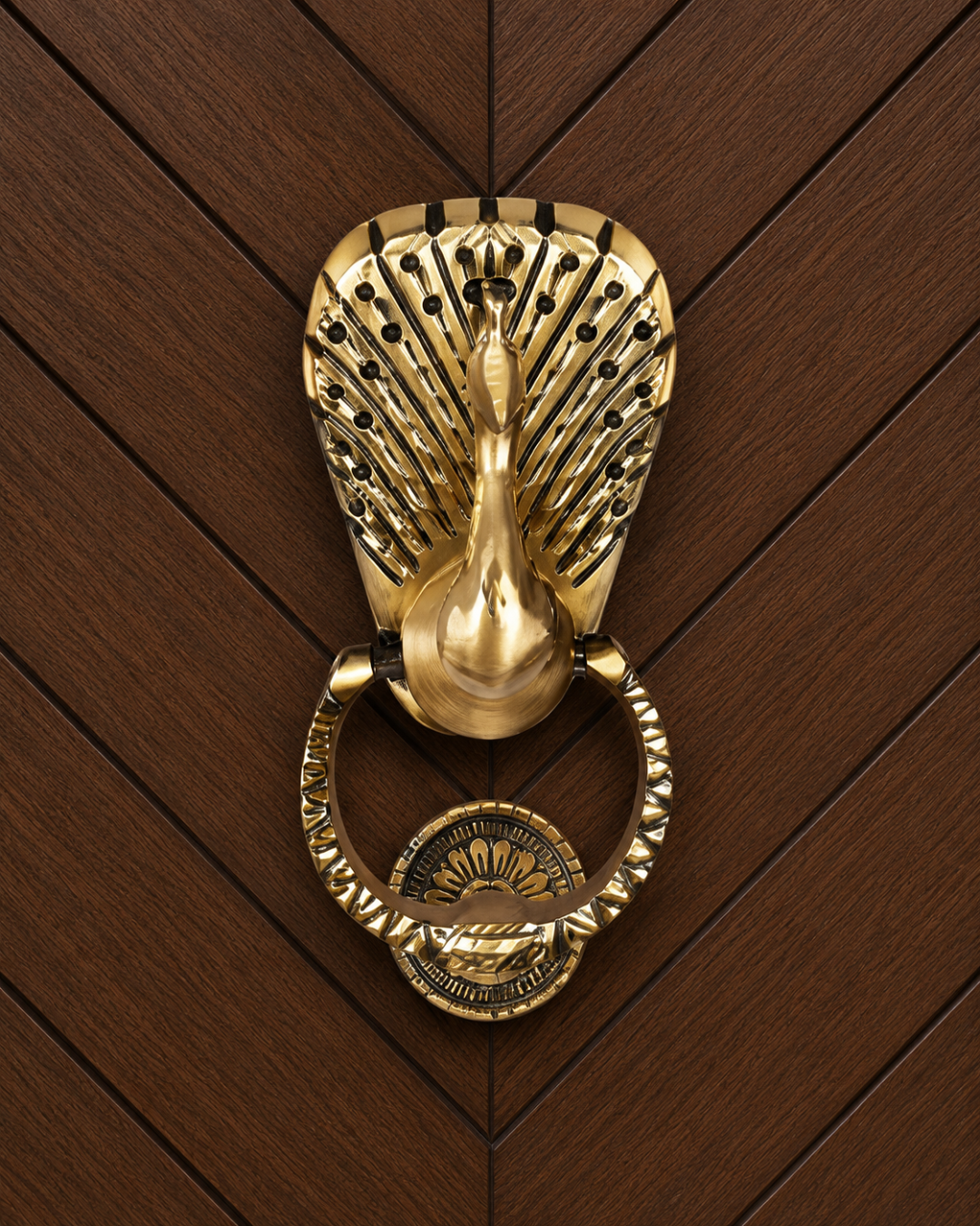 Decorative gold peacock door knocker on a wooden door
