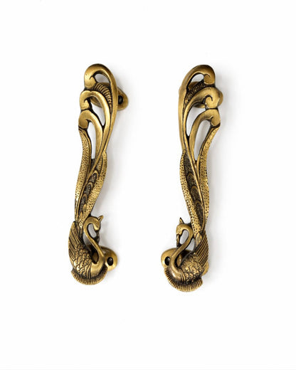 Pair of Swan gold door handles on a white background

