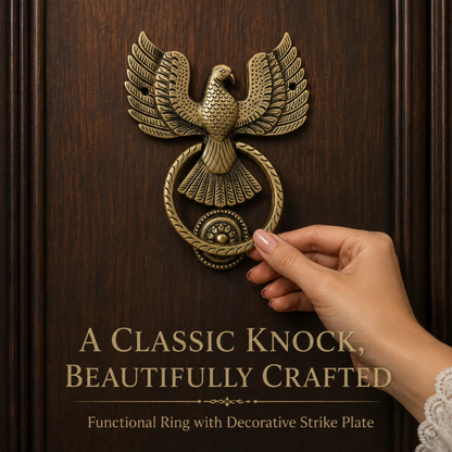 A hand with manicured nails gently touches a decorative brass door knocker shaped like an outstretched eagle above a circular ring. The knocker is mounted on a dark brown wood-paneled door.